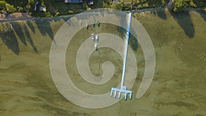 Aerial view of blue plastic pier with fishing boats. Small boats floating on the lake near the pier. Relax concept for