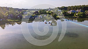 Aerial view of blue plastic pier with fishing boats. Small boats floating on the lake near the pier. Relax concept for design