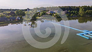 Aerial view of blue plastic pier with fishing boats. Small boats floating on the lake near the pier. Relax concept for design