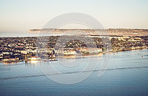 Aerial view of the blue sea and city buildings along the shoreline. San Diego, California.