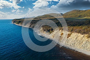 Aerial view of blue sea coast and rock cliffs. Black sea, wild nature, drone flight above water