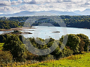 Aerial view of blue water and Menai Strait bridge in rural Wales