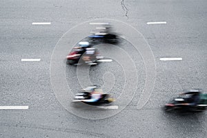 Aerial view of blurred motorbikes on the street in downtown photo