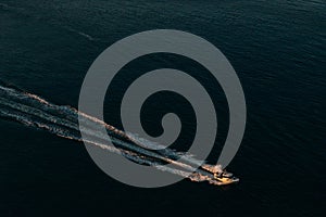 Aerial view of the boat in clear blue water at sunset in summer. Vancouver, canada