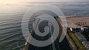 Aerial view of a boat on the Manasquan Inlet heading for the Atlantic Ocean in Manasquan