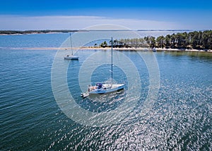 Aerial view of boat sailing on sea with greenery beach