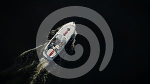 Aerial view. A boat with women and a man captain. Beautiful and rich people are resting.