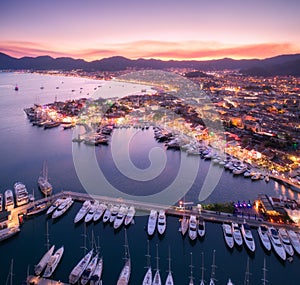 Aerial view of boats and beautiful city at night in Marmaris, Tu