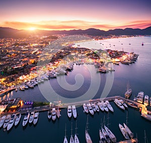 Aerial view of boats and beautiful city at sunset in Marmaris, T