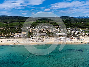 Aerial view on boats, crystal clear blue water of legendary Pampelonne beach near Saint-Tropez, summer vacation on white sandy