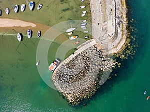 Aerial view of boats in a dry harbour at low tide New Quay, Wales