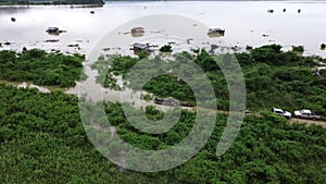 Aerial view of boats and houses flooded in rural Thailand. Top view of the river flowing after heavy rain and flooding in the vill