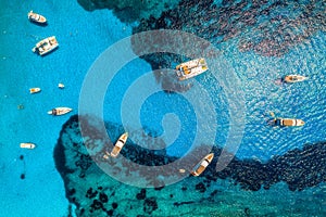 Aerial view of boats and luxury yachts in transparent blue sea