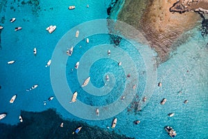 Aerial view of boats and luxury yachts in transparent blue sea