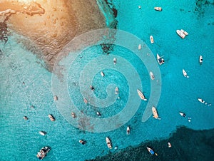 Aerial view of boats and luxury yachts in transparent blue sea