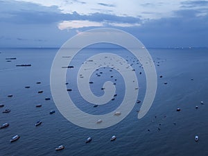 Aerial view of boats in Pattaya sea, beach with sunset sky for travel background. Chonburi, Thailand