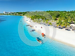 Aerial view of the boats and sea coast with white sandy beach