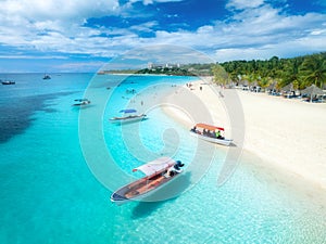 Aerial view of the boats and sea coast with white sandy beach