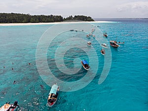 Aerial view of Boats Staying near Mnemba Atoll in Zanzibar - The Famous Spot for Snorkeling and Boat Tour