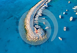 Aerial view of boats and yachts in dock, breakwater and blue sea