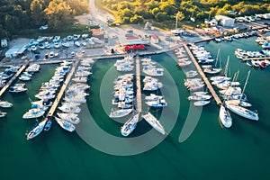 Aerial view of boats and yachts in dock at sunset in summer