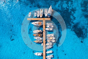 Aerial view of boats and yachts in dock at sunset in summer