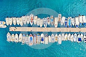 Aerial view of the boats and yachts on sea coast with transparent blue water. Paleokastritsa, Corfu Island, Greece