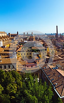 Aerial view of Bologna, Italy at sunset. Colorful sky over the historical city center with car traffic and old buildings roofs.