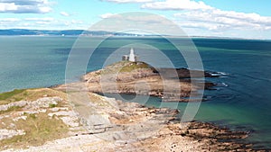 Aerial view of Bracelet Bay the Gower Peninsula South Wales with Mumbles lighthouse, Swansea city,