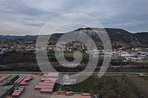 aerial view of brick and construction elements factory building in small town