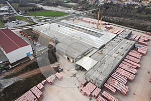 aerial view of brick and construction elements factory building in small town