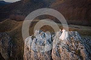 Aerial view of bride standing on a cliff