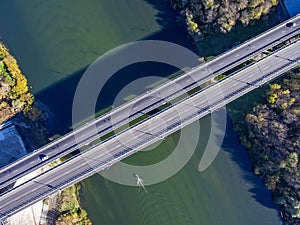 Aerial view of the bridge across the river in autumn sunny day