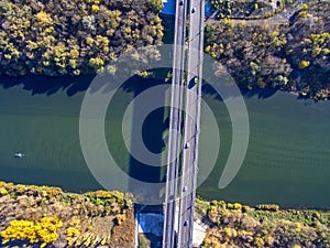 Aerial view of the bridge across the river in autumn sunny day