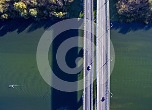 Aerial view of the bridge across the river in autumn sunny day