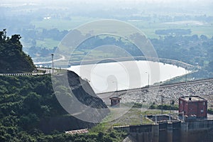 Aerial view of bridge amidst buildings and power plant over river surrounded by landscape at Ajodhya hill, Purulia, in West Bengal