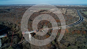 An aerial view of a bridge being built over a valley