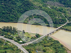 Aerial view of bridge crossing brown river at South Africa`s Wild Coast