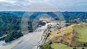 Aerial view on a bridge crossing a river running through mountain valley. Taranaki Region, New Zealand