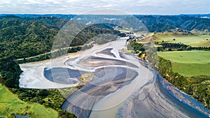 Aerial view on a bridge crossing a river running through mountain valley. Taranaki Region, New Zealand