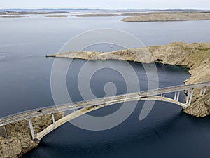 Aerial view of the bridge of the island of Pag, Croatia, road. Cliff overlooking the sea.