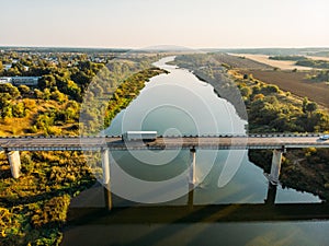 Aerial view of bridge over Don river in Voronezh, autumn landscape from above view with highway road and car transportation