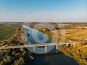 Aerial view of bridge over Don river in Voronezh, autumn landscape from above view with highway road and car transportation