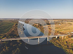 Aerial view of bridge over Don river in Voronezh, autumn landscape from above view with highway road and car transportation