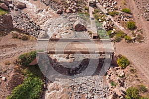 Aerial view of a bridge over the Mendoza River in the Andes Mountain Ridge, Argentina.