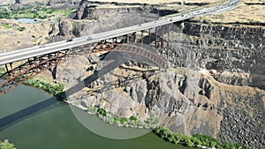 Aerial view of a bridge over a river flowing along the cliffs