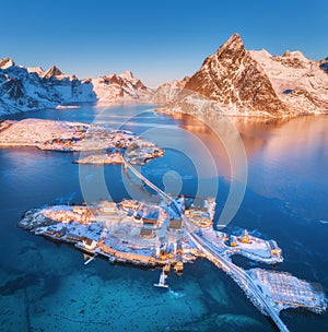 Aerial view of bridge over the sea and snowy mountains in Norway