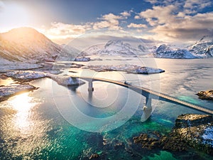 Aerial view of bridge over the sea and snowy mountains in Norway