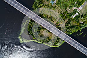 Aerial view of the bridge and the road over the Dnepr River over a green island in the middle of the river