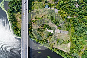 Aerial view of the bridge and the road over the Dnepr River over a green island in the middle of the river